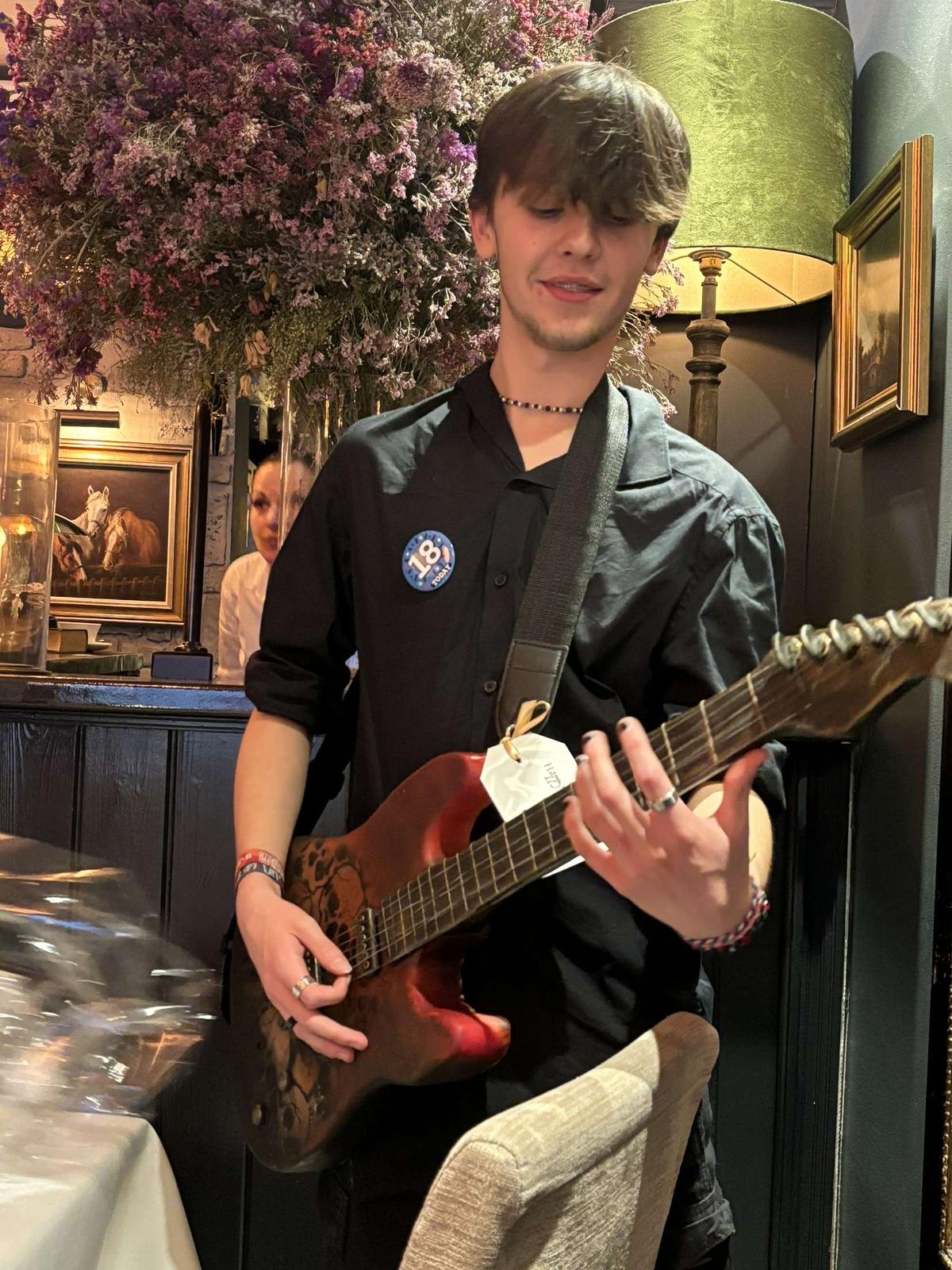 guitar cake being worn and played